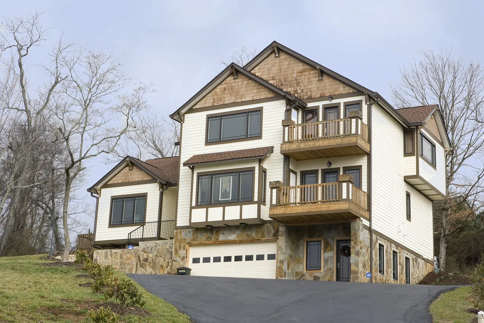 Whispering Pines three-story home plan with balconies and stone accents, built by Buckingham Builders near Asheville, NC